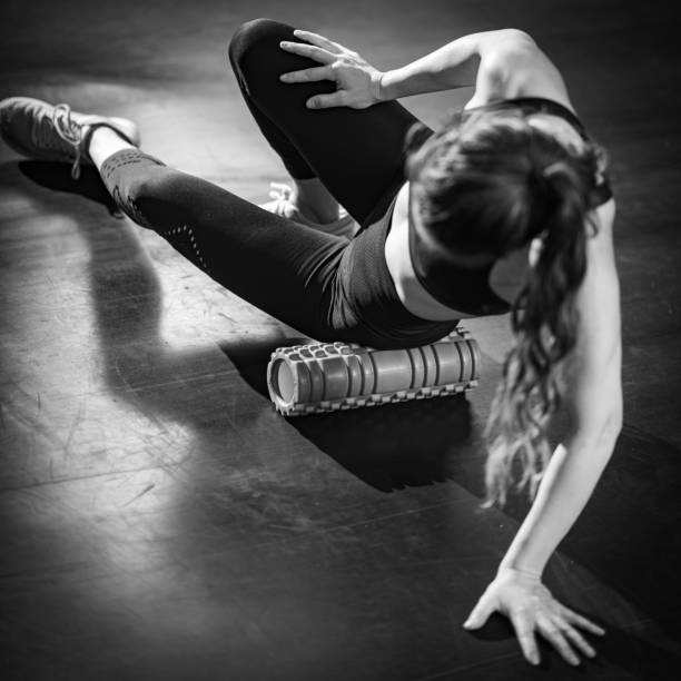 istock Woman Using Foam Roller to Self-Massage Muscles in the gym 1469663263