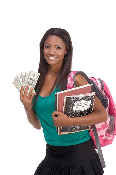 Student holding money representing financial aid and loans stock photo