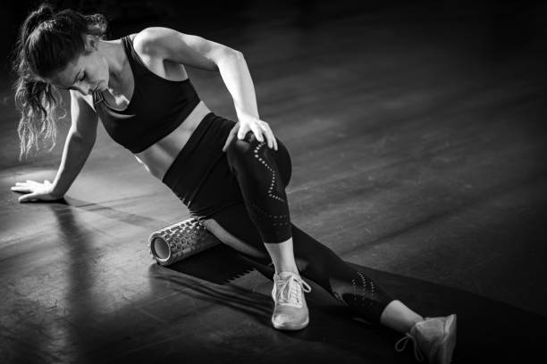 istock Woman Using Foam Roller to Self-Massage Muscles in the gym 1469664093
