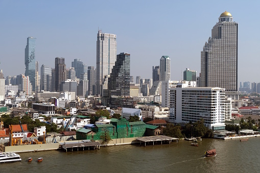 Bangkok modern skyline over the Chao Praya River in Thailand.