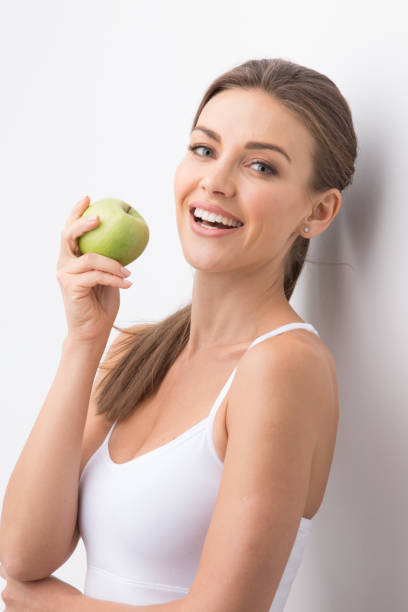 Woman holding green apple stock photo