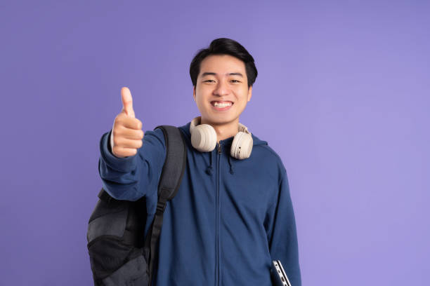 asian male student portrait on purple background - filipino ethnicity audio imagens e fotografias de stock