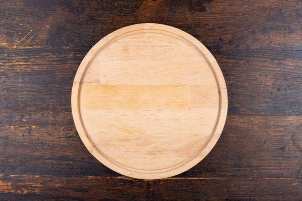 istock Round pizza board on a wooden background. View from above 1469666640