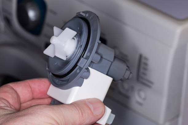 istock Drain pump assembly of modern washing machine in a hand 1469667007