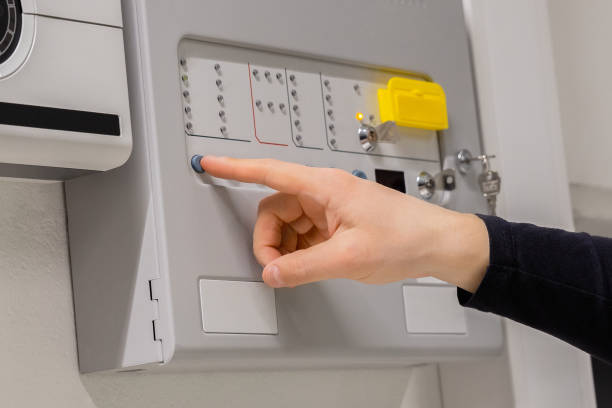 istock Close-up of electrician Checking Fire Alarm Panel In Datacenter 1469669697