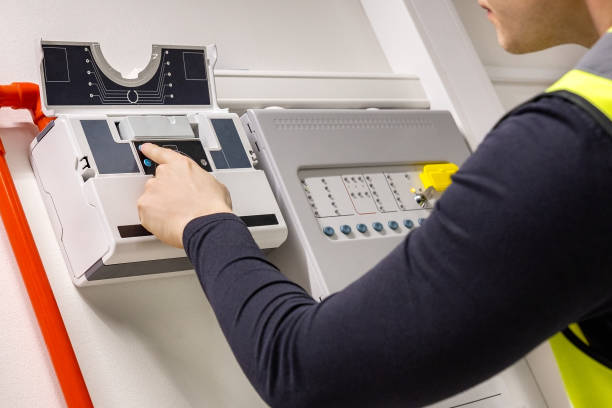 istock Close-up of Male Technician Checking Smoke Detector In Datacenter 1469669754
