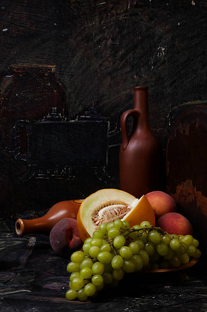 istock Still-life with grapes, a melon, peaches and wine clay bottles 146967116