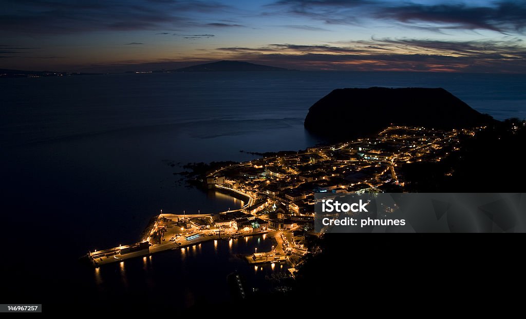 Sunset at the sea Sunset in a small town (Velas) in the SA#o Jorge Island, Portugal. Night Stock Photo