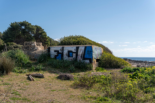 Sa Coma, Spain; february 17 2023: Former Spanish Civil War bunker on the beach of Sa Coma at dawn. Island of Mallorca, Spain