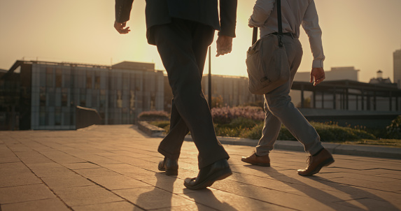 Walking, travel and feet of business men in city for morning commute for work, corporate career and job. Travelling, partnership and shoes of male employees in urban street journey to office building