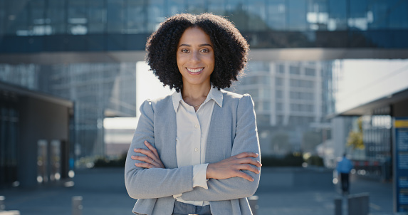 Business, portrait and black woman arms crossed, outdoor and smile for promotion, leadership and success. Face, African American female manager and happy employee with confidence or advertising agent