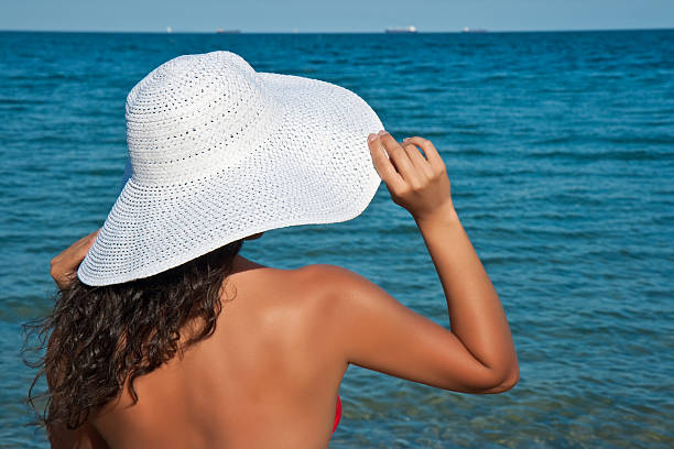 istock Girl in a white hat with fields against the sea 146967440