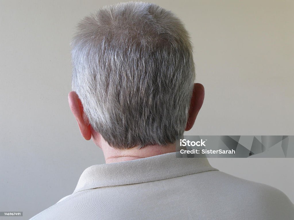 Back of Head Back of head of a senior man against textured outside wall. Concept and idea, in denial and not facing problems, turning one's back on things.  Canon G9. Rear View Stock Photo