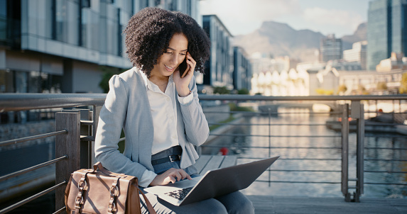 Black woman, business and phone call, laptop in city and networking, communication with tech outdoor. Lawyer, negotiation and email with 5g, discussion and virtual meeting and remote work in Chicago