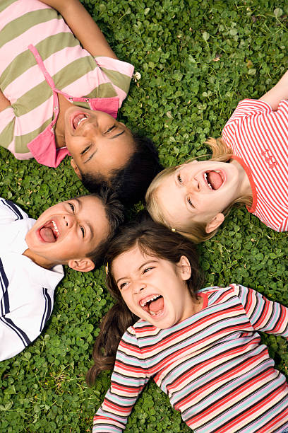 istock Children Lying in Clover Screaming With Heads Together 146967741