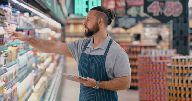 istock Digital tablet, supermarket or worker on pricing app, checklist count idea or fridge stock management. Man, employee or grocery shopping technology of food logistics, sale deal thinking or inflation 1469684265