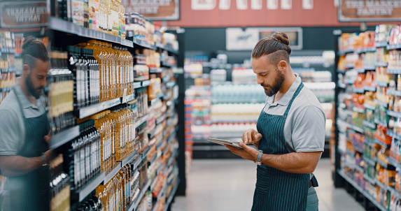 Man, tablet and grocery shopping worker on pricing app, expiry date research or product stock management. Employee, supermarket and retail store technology for inflation strategy or sales deal ideas