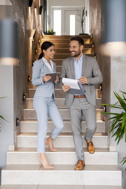 istock Business colleagues standing in modern office and talking about new strategy 1469684603