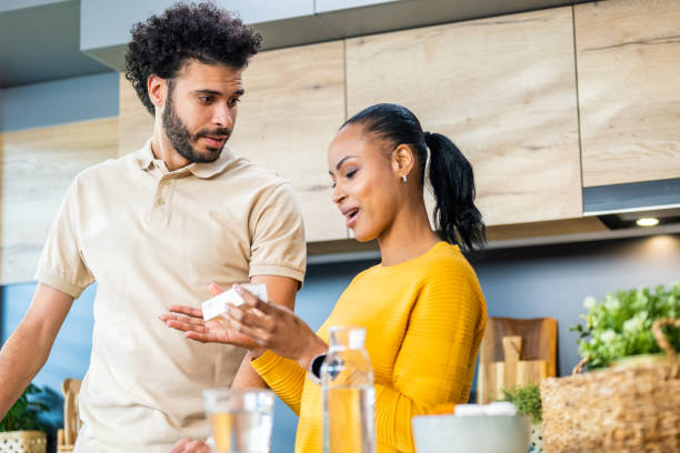istock Couple discussing medication pills instruction 1469686693