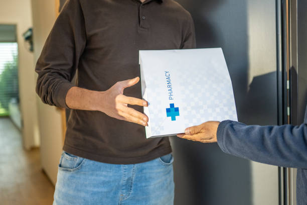 istock Delivery worker giving order from drugstore 1469686694