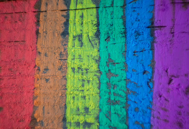 Wooden textured background with the rainbow flag, symbol of gay and freedom, painted with colored chalks