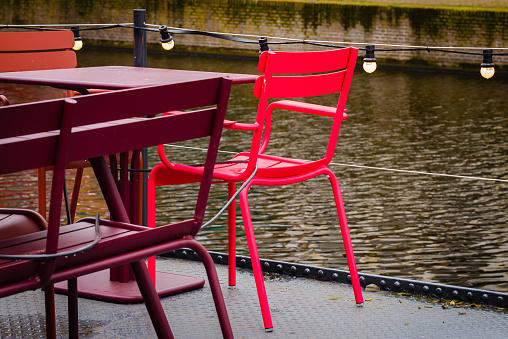 Red chair in caffe on the canal