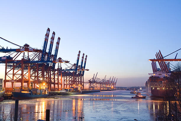 Cargo port Cargo ships in the industrial harbor district in Hamburg, Germany. elbe river stock pictures, royalty-free photos & images