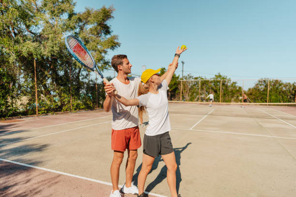istock Young woman practicing tennis with an instructor 1469692499