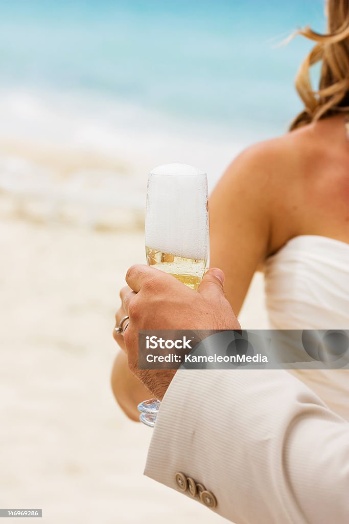 Champagne on the beach Wedding celebration with champagne on the beach Adult Stock Photo
