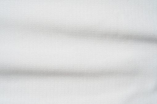 Closeup elegant crumpled of white silk fabric cloth background and texture. Luxury background design.