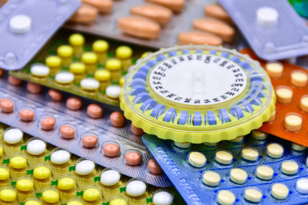 Oral contraceptive pill on pharmacy counter. Oral contraceptive pill on pharmacy counter with colorful pills strips background. birth control pill stock pictures, royalty-free photos & images