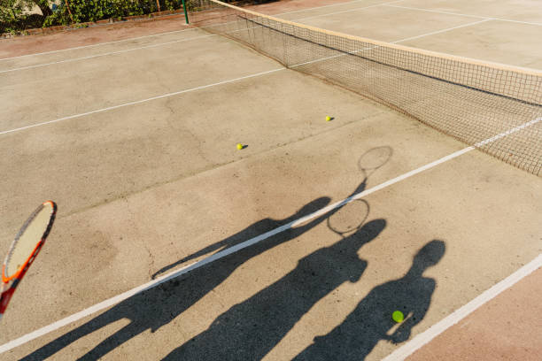 istock Female friends playing tennis 1469698657