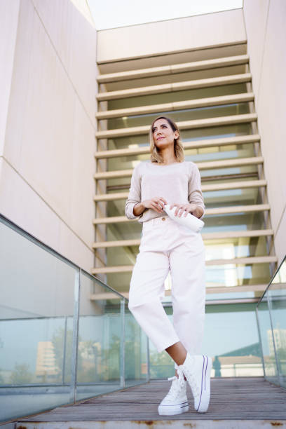 istock Stylish female opening bottle and looking away 1469699478