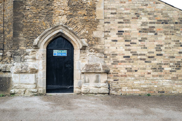 Fire Exit sign seen on an ancient and famous medieval building. The door by law must be kept clear.