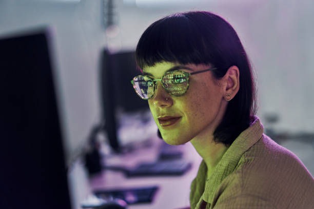 Night, reflection and neon with woman at computer for programmer, cloud computing and software developer. Coding, cybersecurity and technology with employee in digital agency for it, designer or code stock photo