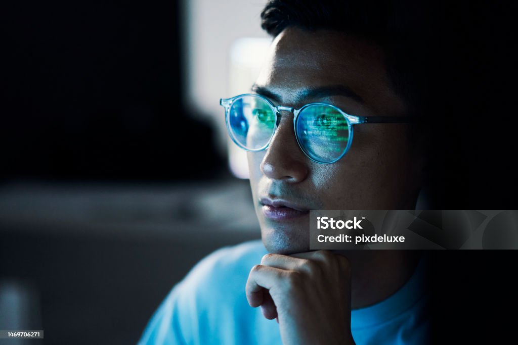 Code,  Asian man  and reflection in glasses, focus and programming for cyber security, hacking and modern office. Japan, male employee with eyewear and IT specialist coding, programming and thinking Technology Stock Photo