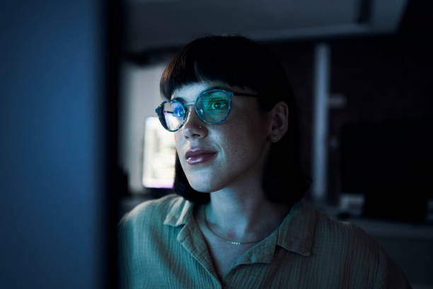 Photo of Glasses, reflection and night with woman and computer for software engineering, developer and designer. Cyber security, data science and code with employee in office for neon, website and html