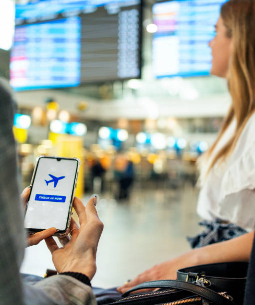 istock Women using a self check-in app in an airport before a flight 1469706284