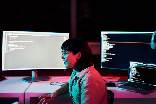 istock Computer, research or woman at night in office for cybersecurity, app coding or speaking. Happy, developer or employee talking and on tech for software code, programming or startup website review 1469706487