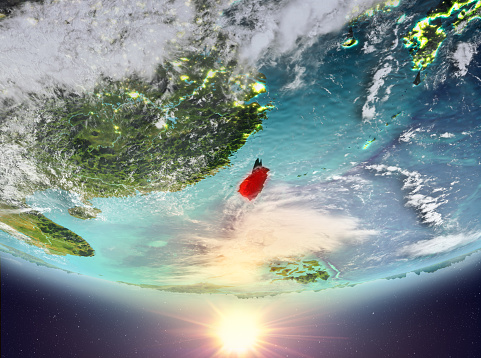 Taiwan during sunrise highlighted in red on planet Earth with clouds. 3D illustration. Elements of this image furnished by NASA.