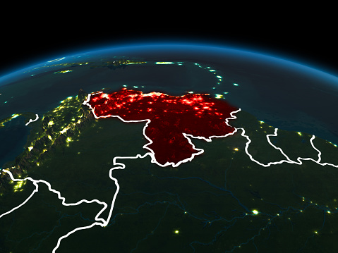 Space orbit view of Venezuela highlighted in red on planet Earth at night with visible country borders and city lights. 3D illustration. Elements of this image furnished by NASA.