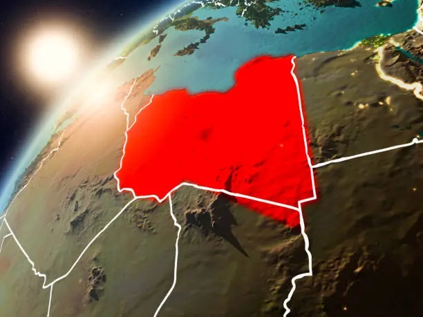 Libya during sunset highlighted in red on planet Earth with visible country borders. 3D illustration. Elements of this image furnished by NASA.