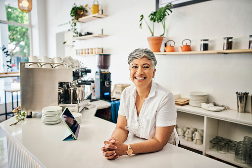 Cafe portrait of woman or small business owner with startup success, restaurant startup and barista services. Boss, manager or Indian senior employer in coffee shop for leadership and a welcome smile