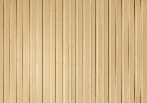 Ribbed wooden wall panels, background texture. Modern wall design with vertical wooden slats