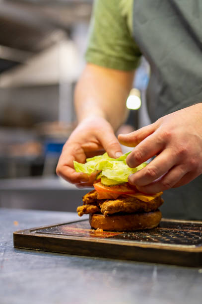 istock chef hand cooking chickenburger on restaurant kitchen 1469727264