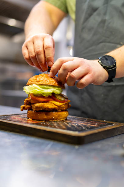 istock chef hand cooking chickenburger on restaurant kitchen 1469727299