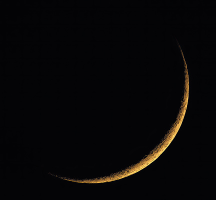 crescent moon rising in the evening