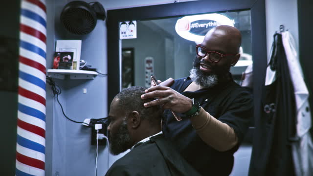 Middle aged black man working in barber shop