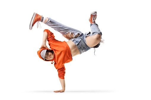 Young female dancer performing a handstand isolated on white background