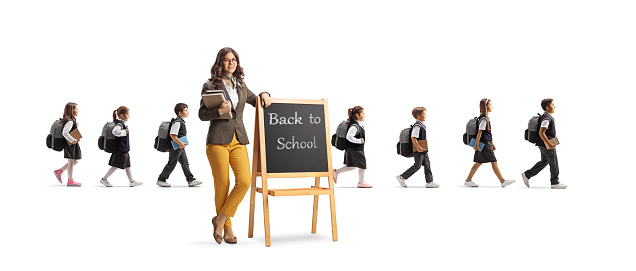 Teacher with blackboard and schoolchildren walking behind isolated on white background